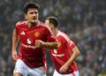 Harry Maguire meraikan jaringan penyamaan pada masa kecederaan sekali gus menyelamatkan Manchester United daripada tewas kepada Porto FC dalam saingan Liga Europa pagi ini. - AFP