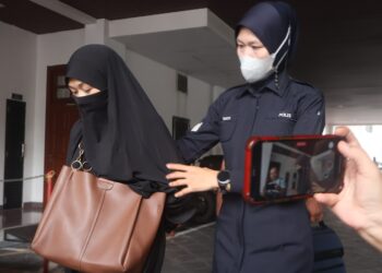 SEORANG ibu tunggal (kiri) dibawa ke Mahkamah Majistret George Town, Pulau Pinang atas pertuduhan membuat kenyataan palsu di laman TikTok, Julai lalu.-UTUSAN/IQBAL HAMDAN