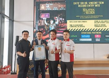 VINCENT Tiew (kiri) menerima Anugerah World Book of Records sempena menyertai 11 Pertandingan Ironman Triathlon dalam tempoh 24 bulan di KL Wellness City Gallery hari ini.