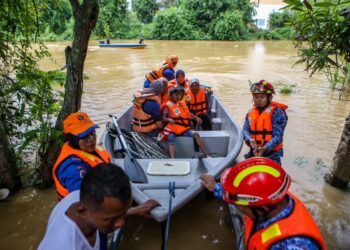 ANGGOTA APM membantu memindahkan mangsa yang terperangkap banjir di Kampung Seberang Anak Bukit di Alor Setar. - UTUSAN/ SHAHIR NOORDIN