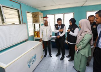 A. SIVANESAN (kiri) membuat pemeriksaan di bahagian kantin SK Chepor di Ipoh hari ini selepas kes keracunan makanan  melibatkan lebih 100 orang murid sekolah tersebut minggu lalu. - UTUSAN/MUHAMAD NAZREEN SYAH MUSTHAFA