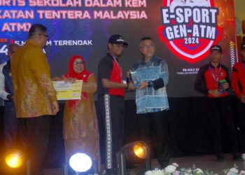 ADLY Zahari menyampaikan hadiah kepada pemenang Pertandingan E-Sukan Sekolah Dalam Kem Angkatan Tentera Malaysia (SDK ATM) di SMK Kem Terendak, Sungai Udang, Melaka. - UTUSAN/AMRAN MULUP