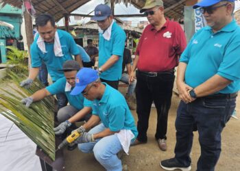 MOHAMAD Pazli Kasim (kiri) menyertai gotong-royong sempena Program Hari Komuniti MyPlus di Dataran Batu Putih, Marang, hari ini. - PUQTRA HAIRRY ROSLI