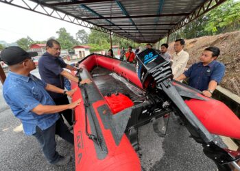 NIK Raisnan Daud (dua dari kiri) melihat bot yang akan digunakan sekiranya berlaku banjir besar di pekarangan Pejabat Tanah dan Jajahan Gua Musang, Kelantan. FOTO: AIMUNI TUAN LAH