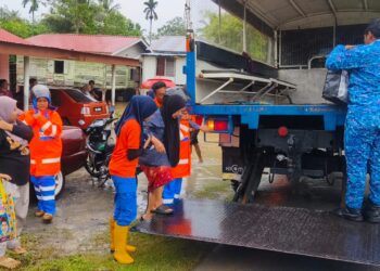 ANGGOTA keselamatan membantu memindahkan mangsa banjir terjejas di Kampung Rambai, Arau, Perlis hari ini. -UTUSAN/ASYRAF MUHAMMAD