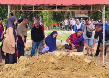 AHLI keluarga menyiram air di pusara Koperal Muhammad Taufik Sayutin di Tanah Perkuburan Islam Felcra Changkat Lada di Kampung Gajah, Pasir Salak hari ini. - UTUSAN