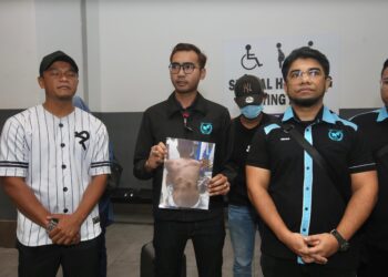 AZIRUL Syafiq Sazali (dua kiri) menunjukkan gambar mangsa yang cedera dipukul ketika menyambut kepulangan mangsa di KLIA. - UTUSAN/AMREE AHMAD