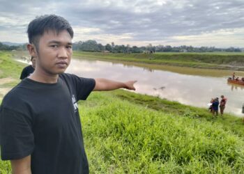 MUHAMMAD Khairul Ikhwan Ismail menunjukkan lokasi bapanya tenggelam ketika mereka memukat di sungai Kampung Paya Parit Lateh, Jitra di Kubang Pasu.