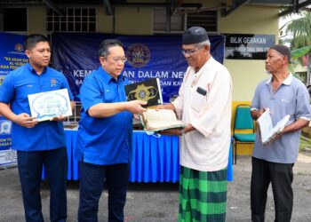 NIK Yusaimi Yussof (dua dari kiri) menyerahkan al-quran baharu kepada penduduk pada Program Jom Exchange (JEQ) di Masjid Taman Maka Utama, Pasir Mas, Kelantan, hari ini. - UTUSAN/KAMARUL BISMI KAMARUZAMAN