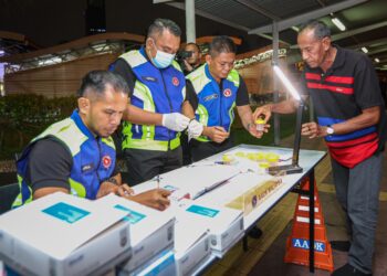 ANGGOTA Agensi Dadah Kebangsaan memeriksa urin pemandu bas semasa operasi khas dan kempen keselamatan jalan raya bersempena perayaan Tahun Baru Cinadi Terminal Bersepadu Selatan (TBS), Kuala Lumpur. - UTUSAN/ISKANDAR ISHAK