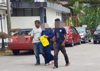 MODUH (kiri) hadir ke Mahkamah Majistret Rembau hari ini bagi didakwa atas pertuduhan mencederakan adik lelakinya dalam kejadian di mukim Chengkau, tahun lalu. - UTUSAN/ NOR AINNA HAMZAH