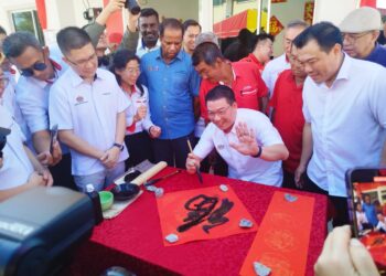 NGA Kor Ming menunjukkan kaligrafi yang beliau hasilkan pada Program Sentuhan Kejayaan Kampung Baru Tahun 2024 di Sungai Siput, Perak hari ini.