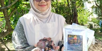 nurul Amirah Yahya menunjukkan produk pes dan salai keluaran syarikatnya.