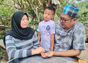 NIK Mohd. Azwa Nik Yahya bersama isteri dan anaknya di Kampung Padang Luas, Besut, Terengganu. -UTUSAN/WAN ZURATIKAH IFFAH WAN ZULKIFLI