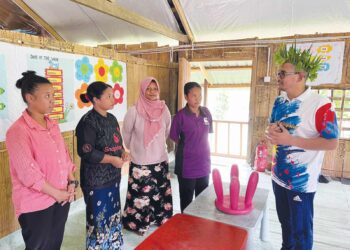 MOHD. Azmawi Fikri Abdul Ghani (kanan) menyantuni guru semasa melawat Pusat Pendidikan Komuniti Pos Gob, Gua Musang, Kelantan. - UTUSAN/AIMUNI TUAN LAH