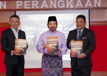 Mohd Uzir Mahidin menunjukkan buku laporan Kajian Pengurusan Kes-Kes Di Mahkamah Perusahaan Malaysia (MPM) pada Majlis Pelancaran Buku Laporan Kajian Pengurusan Kes-Kes Di Mahkamah Perusahaan Malaysia (MPM) di Putrajaya, hari ini. UTUSAN/FAISOL MUSTAFA