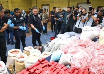 KHAW Kok Chin (tiga dari kiri) bersama Ketua Polis Selangor, Datuk Hussein Omar Khan (dua dari kiri) menunjukkan sejumlah dadah dan senjata api yang dirampas dalam serbuan di sebuah gudang di Taman Industri Alam Jaya, Puncak Alam, Selangor, semalam. – UTUSAN/SADDAM YUSOFF 