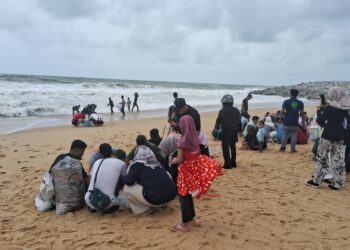 ORANG ramai masih mengutip kerang di Pantai Sura, Dungun, Terengganu meskipun larangan aktiviti itu  dikeluarkan polis. -UTUSAN/NIK NUR IZZATUL HAZWANI NIK ADNAN