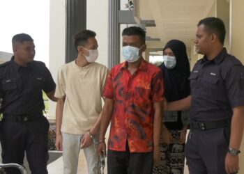 ANGGOTA polis mengiringi Lim Wu Han (dua dari kiri) Rajmidi Sahli (tengah) dan Nursyuhada Abdullah selepas didakwa atas pertuduhan menggunakan pangkalan haram di Mahkamah Majistret Pasir Mas, Kelantan. - UTUSAN/ROSALWANI CHE SOH