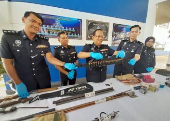 YUSOF Othman menunjukkan senjata yang dirampas daripada dua lelaki dalam sidang akhbar di IPD Kota Tinggi - UTUSAN