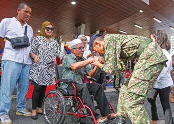 MUHAMMAD Aziq Hazimi Norawi bersalam dengan datuknya, Md. Jidi Zainal selepas Perbarisan Tamat Latihan PLKN 3.0 Siri 1/25 di Rejimen 515 Askar Wataniah, semalam. – UTUSAN/ISKANDAR ISHAK