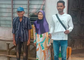 MOHAMAD Azrol Nor Akmar Qomarudin (kanan) bersama keluarga angkatnya di Kampung Perak, Pulau Tawar, Pahang. – UTUSAN/HARIS FADILAH AHMAD