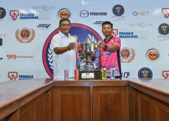 KETUA jurulatih THT, Mohd. Harfizi Baharom (kanan) dan ketua jurulatih TNB, Nor Saiful Zaini (kiri) memegang Piala TNB menjelang aksi final di Stadium Hoki Nasional Bukit Jalil, hari ini.