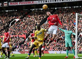 Pemain Manchester United, Manuel Ugarte menanduk bola ke gawang Crystal Palace dalam saingan Liga Perdana Inggeris di  Old Trafford, kelmarin. - AFP