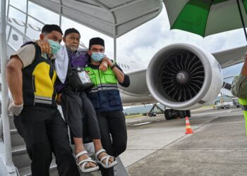 PETUGAS lapangan terbang membantu jemaah selepas menunaikan ibadah haji di Lapangan Terbang Antarabangsa Sultan Iskandar Muda di Aceh, Indonesia pada Julai tahun lalu. – AFP