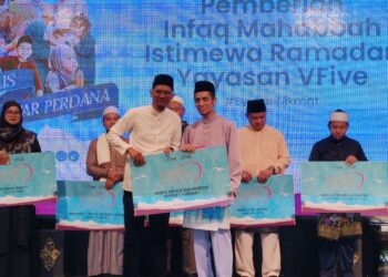 DATUK Mohd Syafiq Abdullah (kanan) menyampaikan replika cek sumbangan Infaq Mahabbah Ramadan kepada penerima semasa majlis Iftar Perdana, semalam.