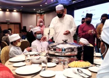 ANNUAR Musa beramah mesra bersama pelajar-pelajar tahfiz dari Maahad Tahfiz Al-Ihya pada majlis berbuka puasa di Seremban semalam. - FOTO/BADRUL HAFIZAN MAT ISA