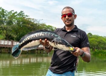 Roob Ganesan menujukkan ikan Toman seberat lima kilogram yang dipancing di Tasik Rekreasi Putrajaya.