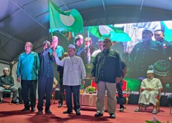 HUSAIN Awang (dua dari kanan) menyerahkan bendera Pas kepada salah seorang wakil Majlis Tindakan Dewan Undangan Negeri dalam Majlis Perasmian Markas Induk dan Pelancaran Jentera PRU15 Kawasan Parlimen Kuala Terengganu di Kuala Ibai, Kuala Terengganu, malam tadi.