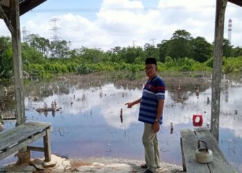 AB. SAMIR MAHADI menunjukkan Tanah Perkuburan Islam Kampung Sungai Dinar, Serkat, Pontian yang ditenggelami air pasang besar.