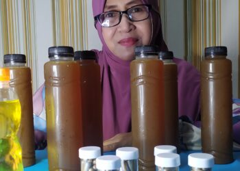 Aishah Ibrahim bersama jamu Air Asam Kunyit.