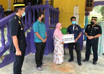 AMINURRAHIM Mohamed (dua dari kanan) menyampaikan kepada Mek Limoh Ismail di Kampung Karang, Banggu, Kota Bharu, Kelantan. - FOTO/ROSLIZA MOHAMED