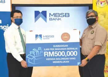 NOR Azam M. Taib (kiri) menyampaikan replika cek sumbangan MBSB kepada Pengarah Seksyen Pembangunan Komuniti dan Sosial Nadma, Hussain Moh. - GAMBAR/MBSB BANK