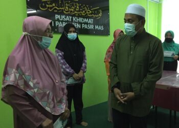 AHMAD Fadli Shaari bertanya khabar Wan Khadijah Wan Ibrahim, salah seorang mangsa runtuhan tebing di Kampung Pohon Chelagi, Pasir Mas. - UTUSAN/YATIMIN ABDULLAH