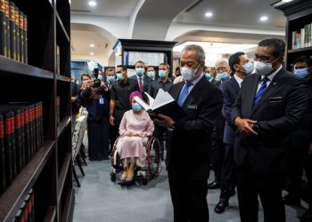 MUHYIDDIN Yassin bersama Menteri di Jabatan Perdana Menteri (Parlimen dan Undang-Undang), Datuk Takiyuddin Hassan (kanan) melihat koleksi-koleksi buku yang terdapat di Perpustakaan Parlimen Malaysia selepas merasmikannya di Bangunan Parlimen, Kuala Lumpur, semalam. - FOTO/FARIZ RUSADIO