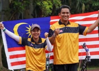 FATIN Nur Fatehah Mat Salleh (kiri) dan Juwaidi Mazuki meraikan kejayaan memenangi pingat emas memanah compound beregu campuran Sukan SEA 2021 di  Pusat Latihan Sukan Negara, Hanoi hari ini -  UTUSAN/SHIDDIEQIIN ZON