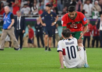 Pemain Maghribi, Yahya Attiyallah cuba menenangkan pemain Portugal, Bernardo Silva selepas perlawanan tamat, kelmarin. - AFP