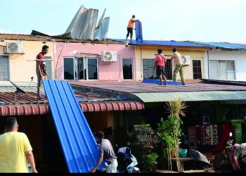 PENDUDUK Indera Mahkota 2, Kuantan, Pahang, bergotong-royong membaiki bumbung rumah mereka yang rosaK selepas dipukul ribut malam semalam.