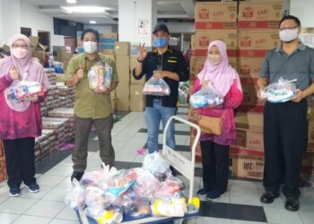 ROSYAM Nor (tengah) dan Zamani Ahmad Mansor (dua kiri) menunjukkan sumbangan itu di Bilik Gerakan Banjir di Wisma MBSA Shah Alam, Selangor, hari ini.