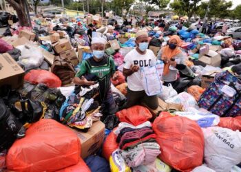 ORANG ramai mengumpulkan barangan keperluan di Stadium Tuanku Abdul Rahman, Paroi, Seremban untuk disumbangkan kepada mangsa yang terjejas banjir di Negeri Sembilan dan Selangor.-	UTUSAN/MOHD. SHAHJEHAN MAAMIN.