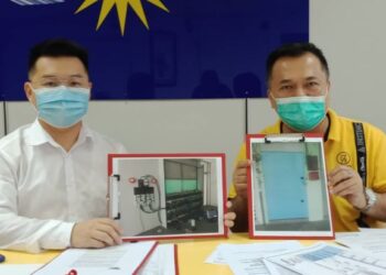 TENG Hwa Ling (kanan) dan Law Guo Nan menunjukkan gambar premis yang dijadikan lombong aktiviti bitcoin pada sidang akhbar di Pejabat MCA Perak di Ipoh hari ini. - FOTO/ZAKI SALLEH