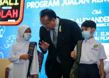 ALEXANDER Nanta Linggi beramah mesra dengan anak kakitangan KPDNHEP Qaireen Amani Che Razali (kiri) dan Muhammad Syabil Qushaiyyi Samri pada Majlis Pelancaran Program Jualan Kembali Ke Sekolah di KPDNHEP, Putrajaya, di sini, hari ini.-UTUSAN/ FAISOL MUSTAFA