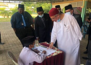 ZULKIFLI Mohamad Al Bakri bertanyakan sesuatu kepada pelajar di pada majlis penutup Program Semarak Jawi sempena Bulan Kebangsaan di Sekolah Rendah Agama An-Najah, Presint 9, di sini semalam.-UTUSAN/ SUBKHI SUDARJI