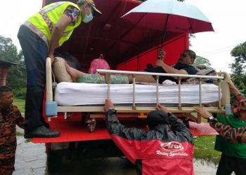 MANGSA banjir, Baharun Mohamed yang mengalami lumpuh dari Kampung Felda Seberang Tayor di Kemaman dipindahkan menggunakan lori berikutan terpaksa membawa katil khas miliknya ke pusat pemindahan sementara, semalam. - UTUSAN/NIK NUR IZZATUL HAZWANI NIK ADNAN