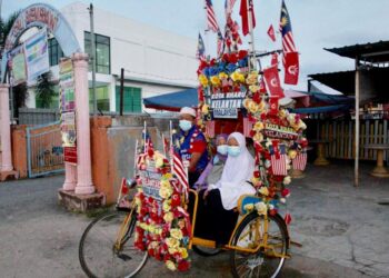 CHE KAMARUDDIN menghantar pasangan kembarnya ke SK Sri Bemban dengan menaiki beca pagi ini. -UTUSAN/ROHANA MOHD. NAWI