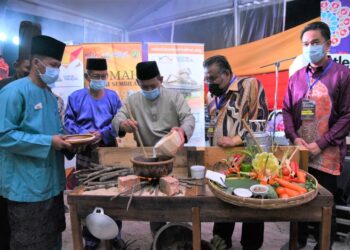 AMINUDDIN Harun mencuba masakan sempena pelancaran MAH Negeri Sembilan Food Festival 2021 di Port Dickson. - UTUSAN/ZAKKINA WATI AHMAD TARMIZI